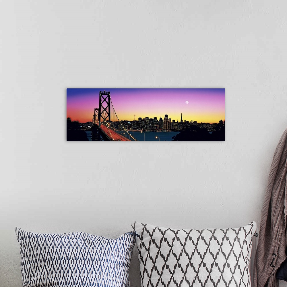 A bohemian room featuring Stunning panoramic photo of a suspension bridge in California at twilight, with a large city and ...
