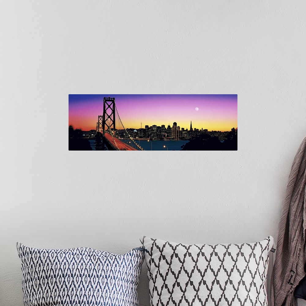 A bohemian room featuring Stunning panoramic photo of a suspension bridge in California at twilight, with a large city and ...