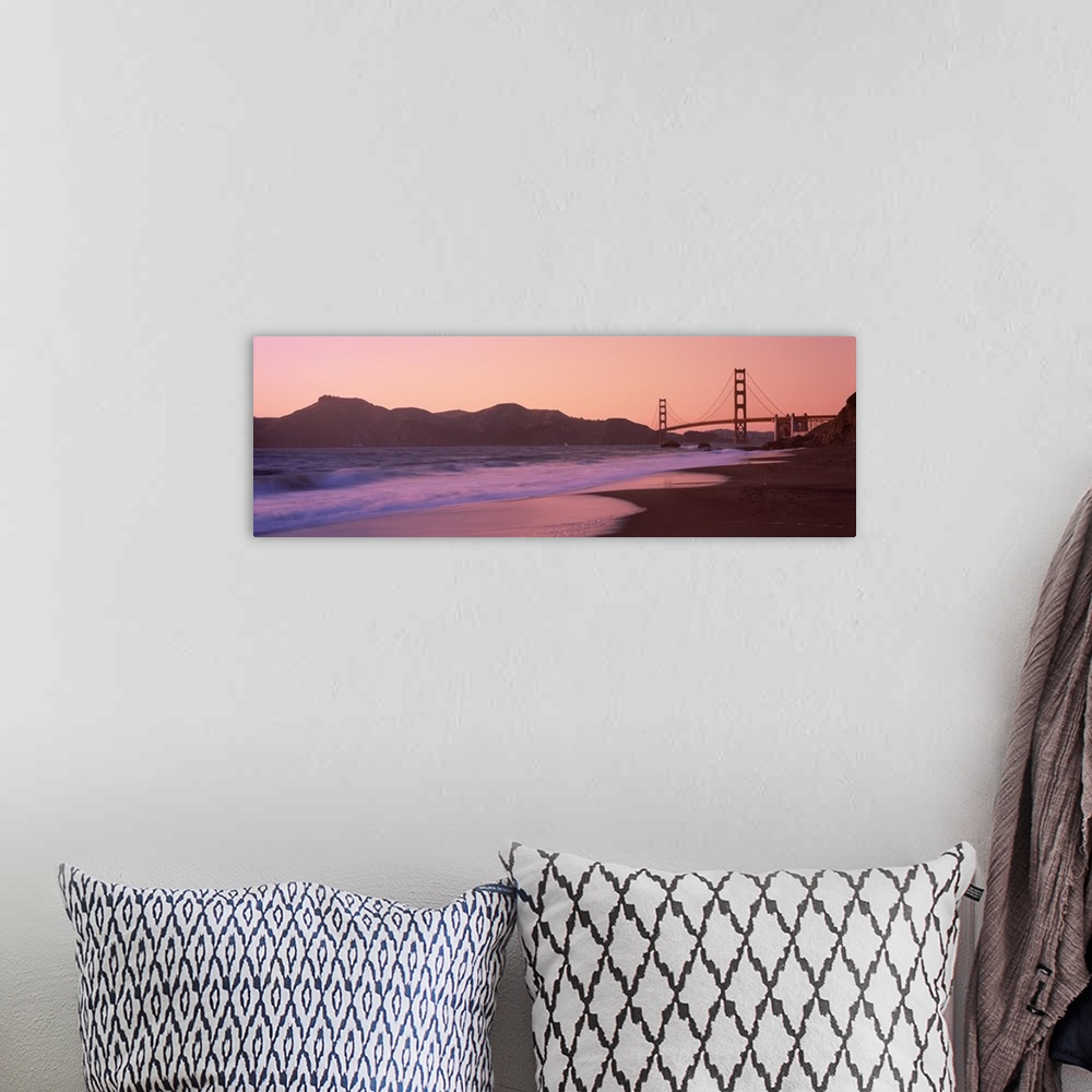 A bohemian room featuring Photograph taken from a distance of the Golden Gate Bridge and the cliffs just beside it. The sun...