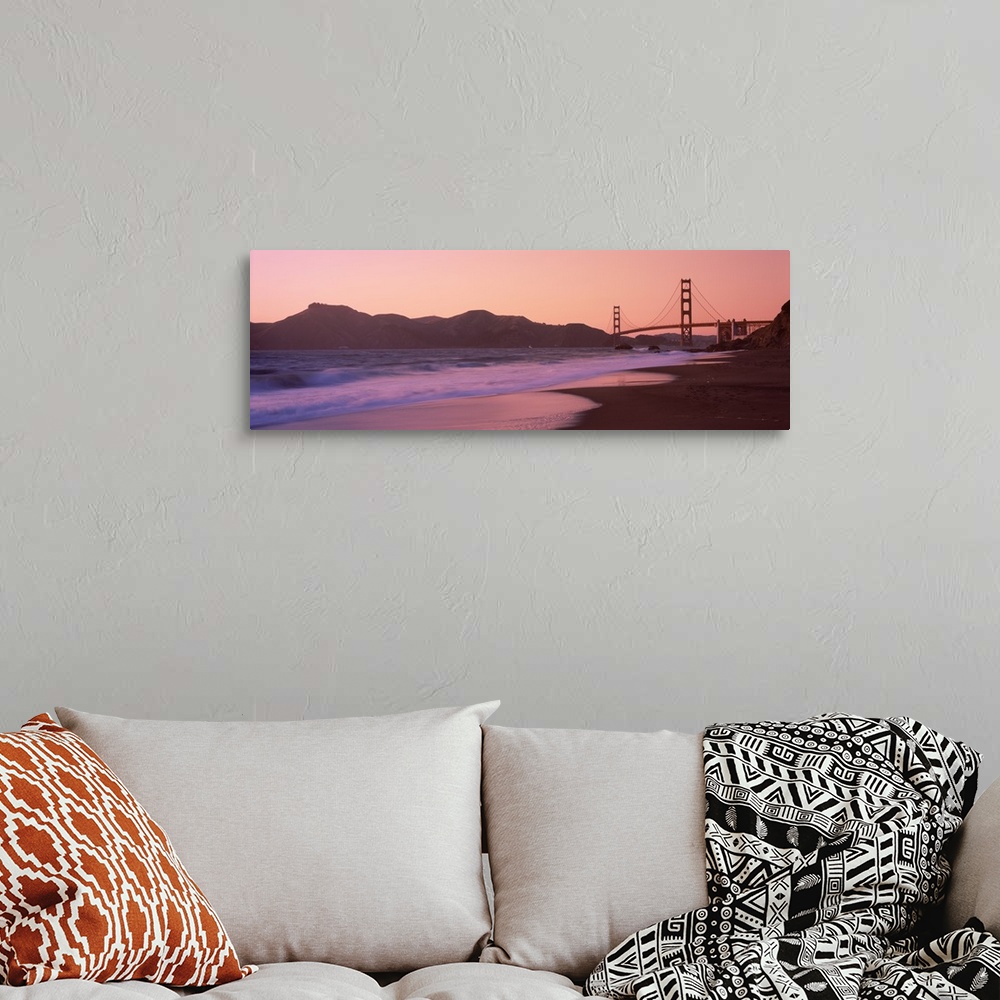 A bohemian room featuring Photograph taken from a distance of the Golden Gate Bridge and the cliffs just beside it. The sun...