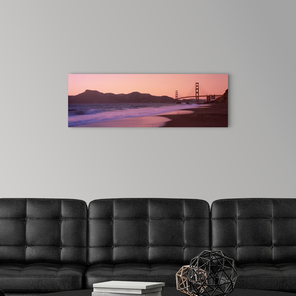 A modern room featuring Photograph taken from a distance of the Golden Gate Bridge and the cliffs just beside it. The sun...