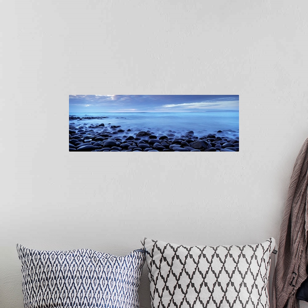 A bohemian room featuring Panoramic photograph shows the shores of a beach in the United Kingdom filled with smooth stones ...