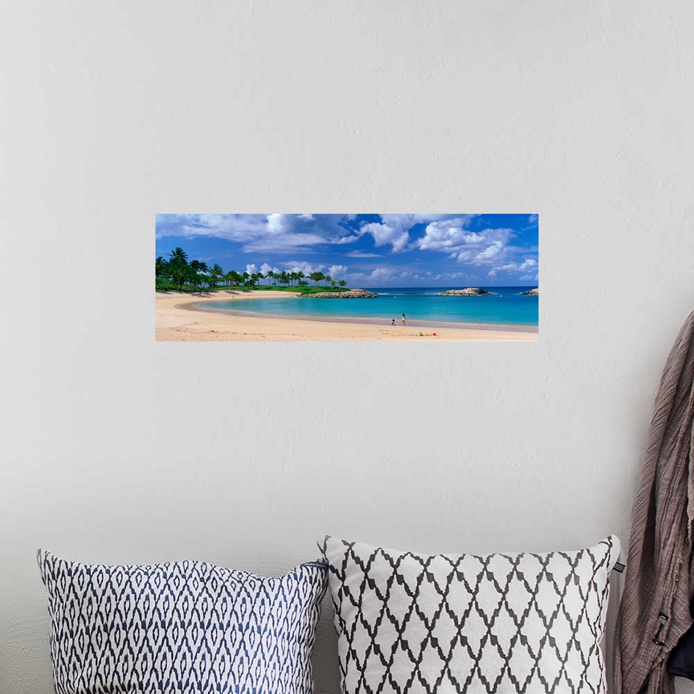 A bohemian room featuring A panoramic photograph of a tropical cover on an island lined with palm trees and clear water.