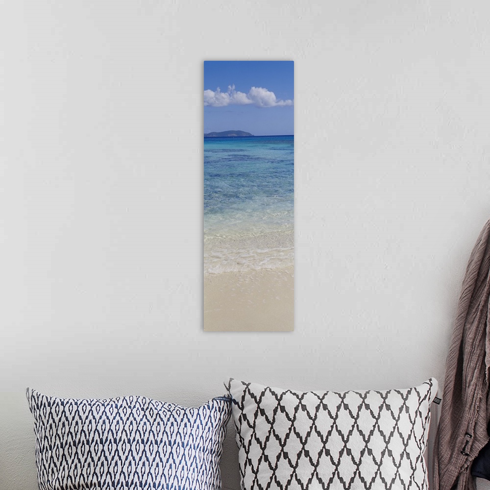 A bohemian room featuring Vertical panoramic photograph of ocean waves washing up to shore with an island in the distance u...