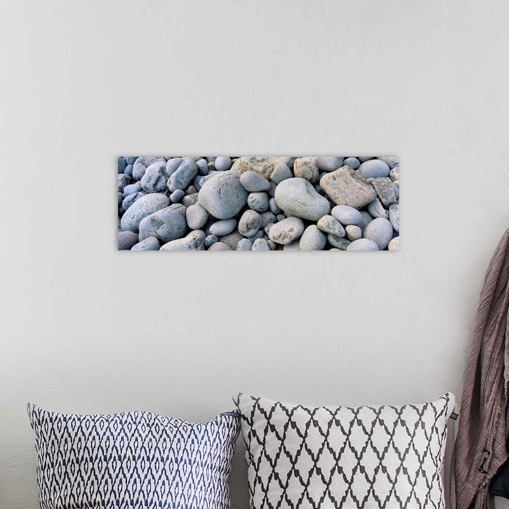 A bohemian room featuring Up-close panoramic photograph of seaside pebbles and rocks.