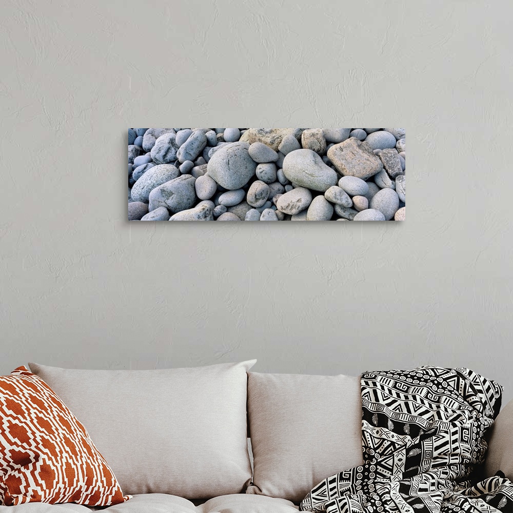 A bohemian room featuring Up-close panoramic photograph of seaside pebbles and rocks.
