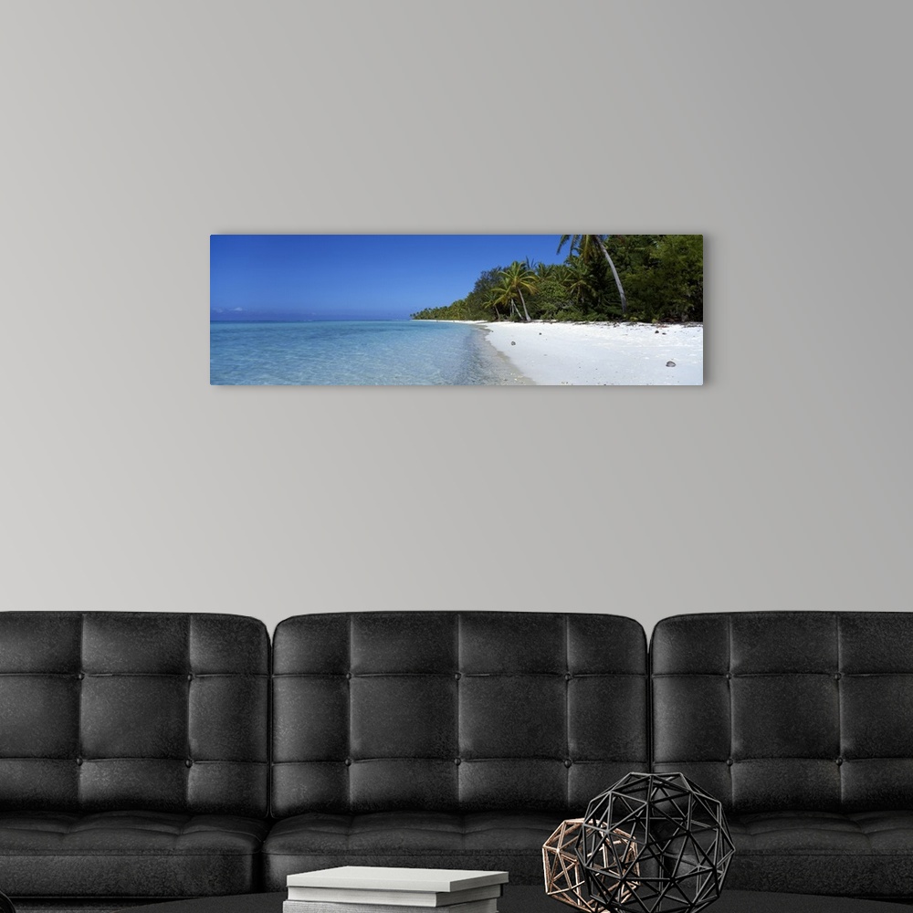 A modern room featuring Panoramic photograph of clear blue waters over the atoll near Beach Tetiaroa in Tahiti.  The beac...