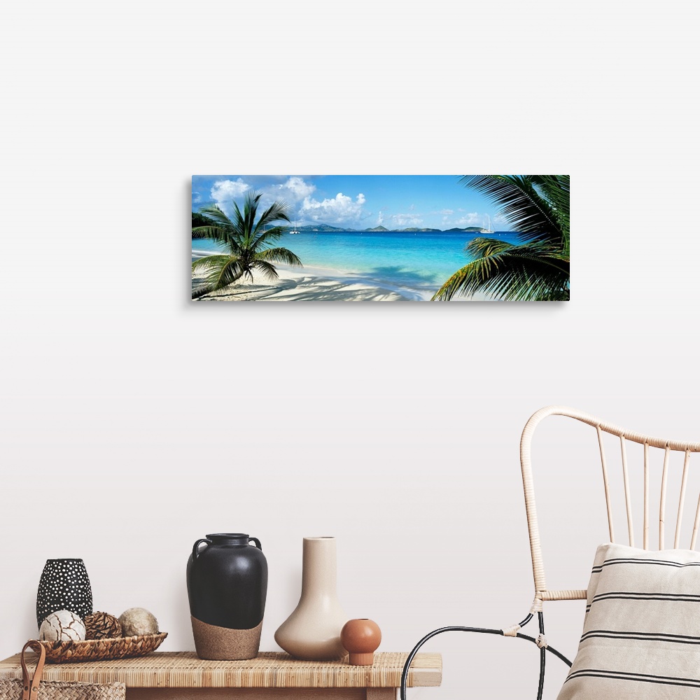 A farmhouse room featuring Wide panoramic photograph of windswept trees on a tropical beach with sail boats in the harbor.