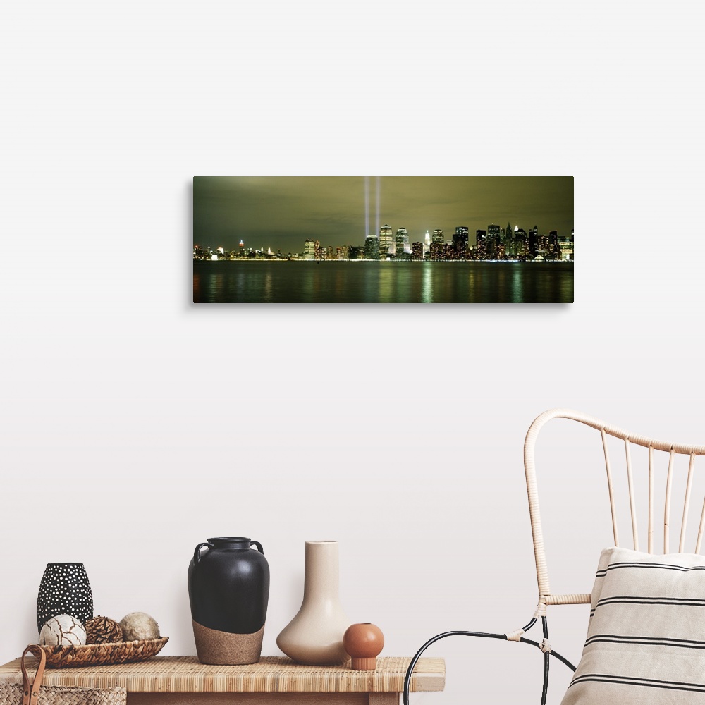 A farmhouse room featuring Panoramic cityscape on canvas of NYC lit up with two beacons of light shooting upwards in place o...