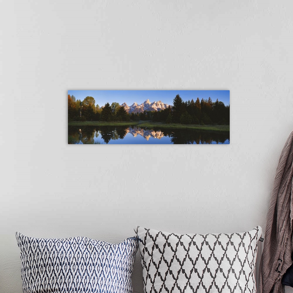 A bohemian room featuring Panoramic photo on canvas of a rugged mountain range in the distance of a tree line and a lake wi...