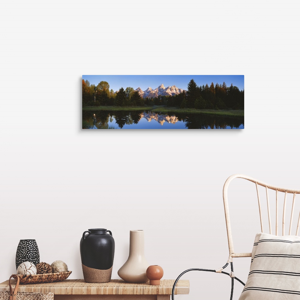 A farmhouse room featuring Panoramic photo on canvas of a rugged mountain range in the distance of a tree line and a lake wi...
