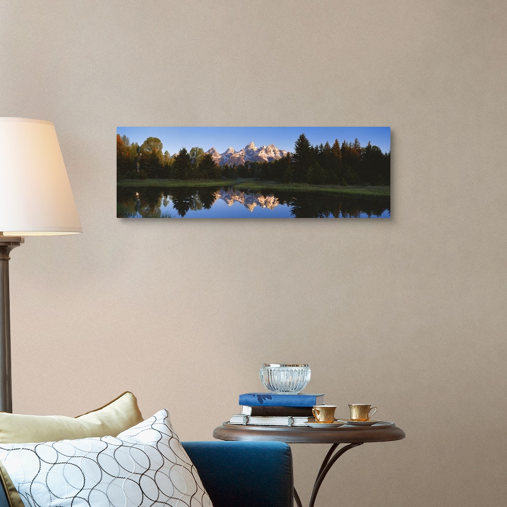 A traditional room featuring Panoramic photo on canvas of a rugged mountain range in the distance of a tree line and a lake wi...