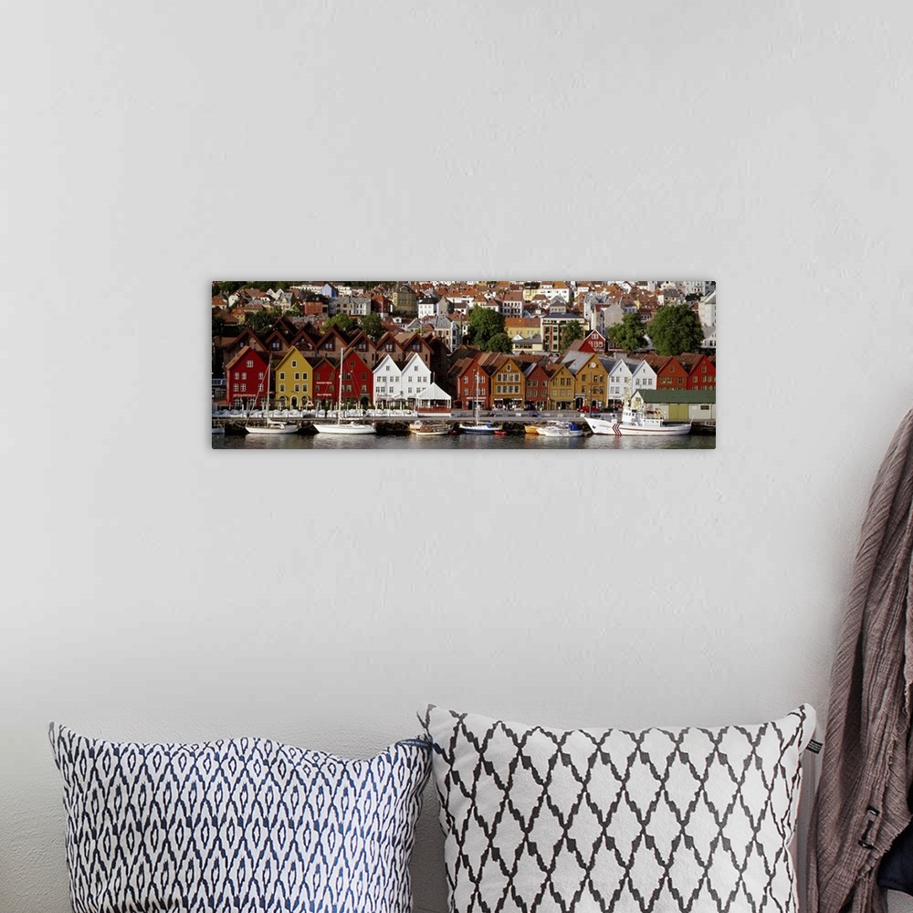 A bohemian room featuring This is a panoramic photograph of a coastal town in Northern Europe lining a harbor full of boats.