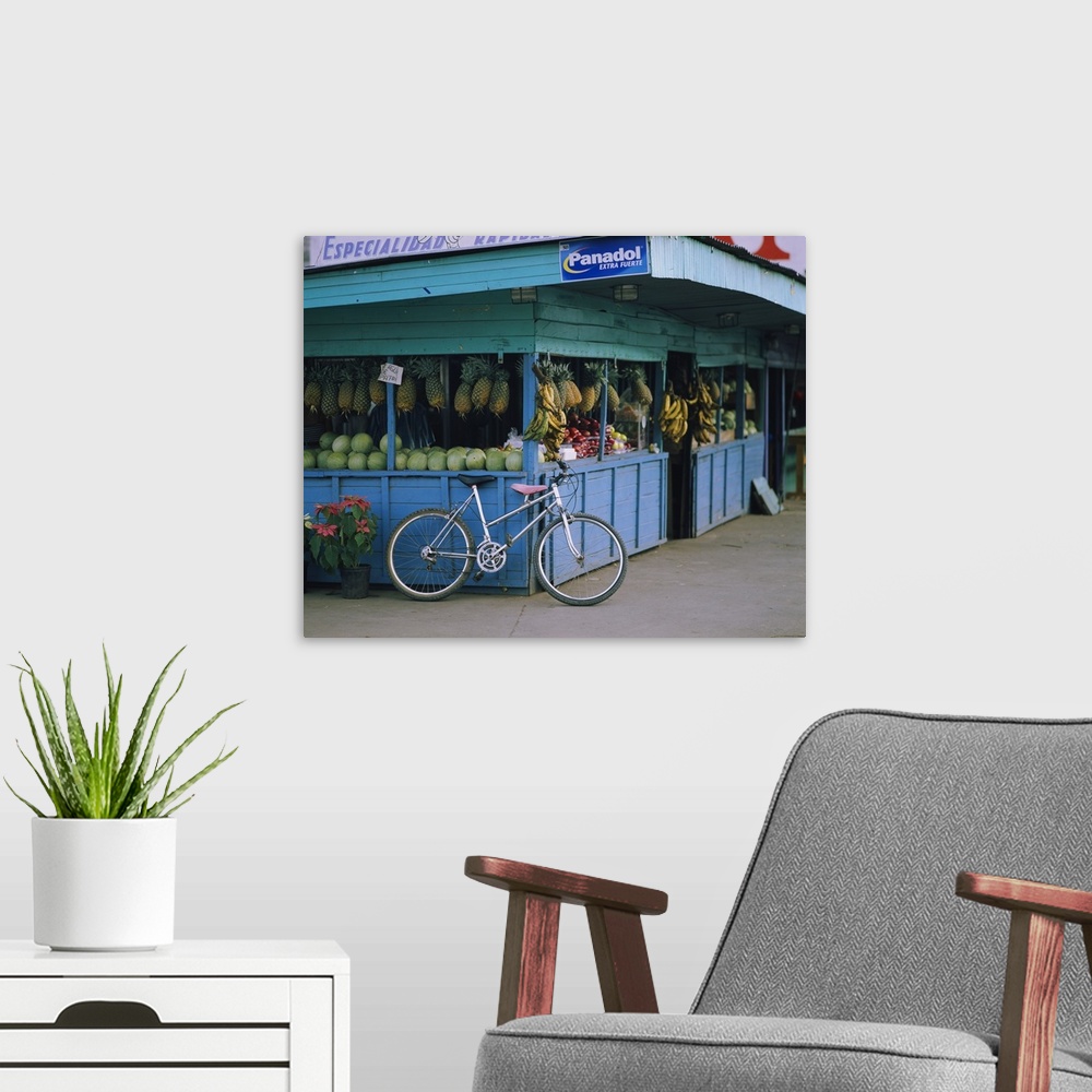 A modern room featuring Bicycle leaning against a fruit stand, Costa Rica