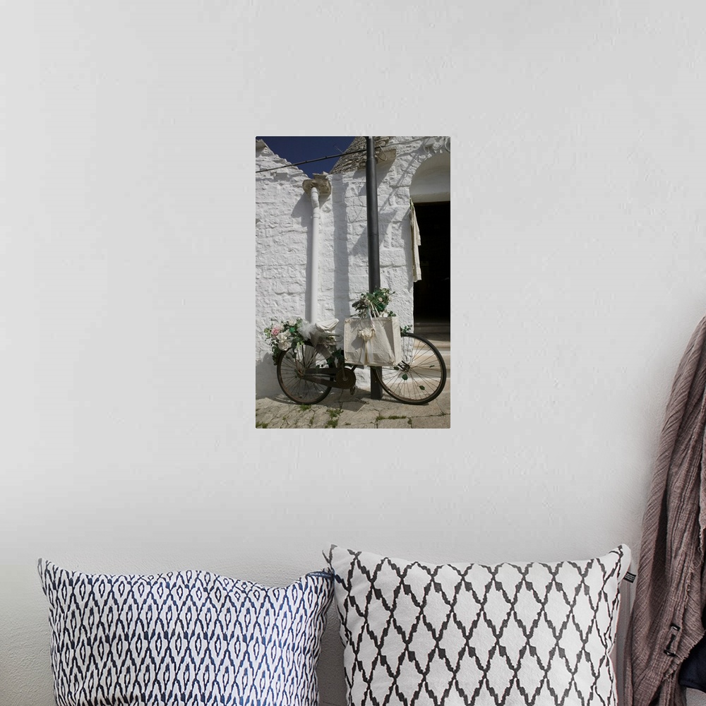 A bohemian room featuring Bicycle parked against a pole, Trulli House, Alberobello, Apulia, Italy