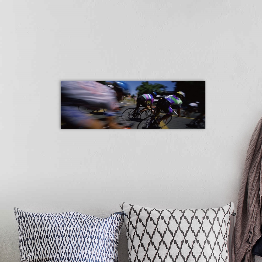 A bohemian room featuring Panoramic blur motion photograph of cyclists racing on the street.