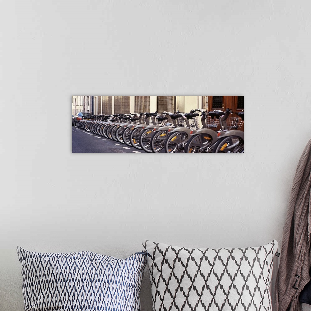 A bohemian room featuring Panoramic photograph of street lined with bikes.