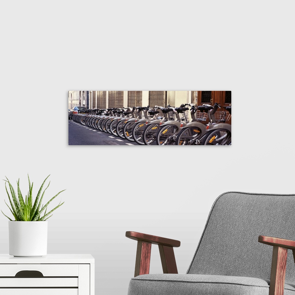 A modern room featuring Panoramic photograph of street lined with bikes.