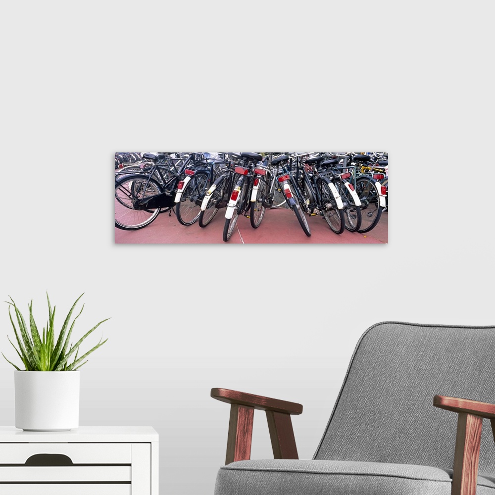 A modern room featuring Bicycles parked in a parking lot, Amsterdam, Netherlands