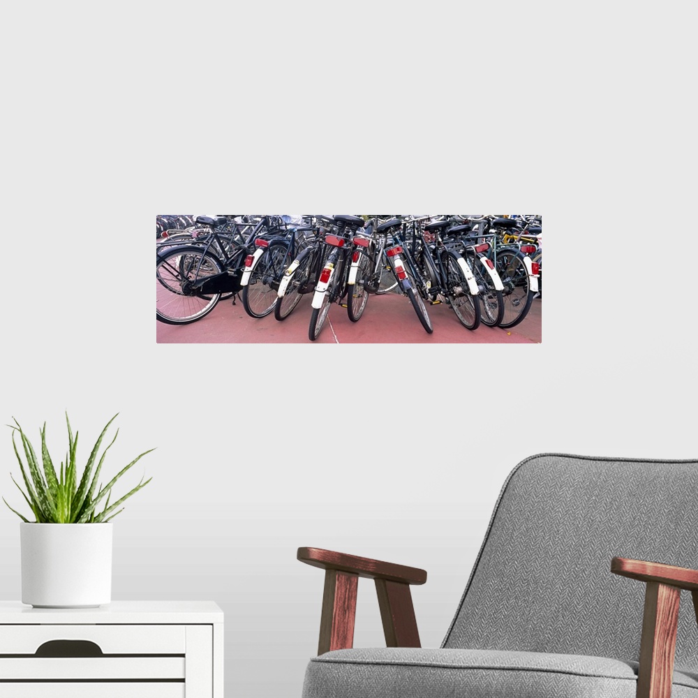 A modern room featuring Bicycles parked in a parking lot, Amsterdam, Netherlands
