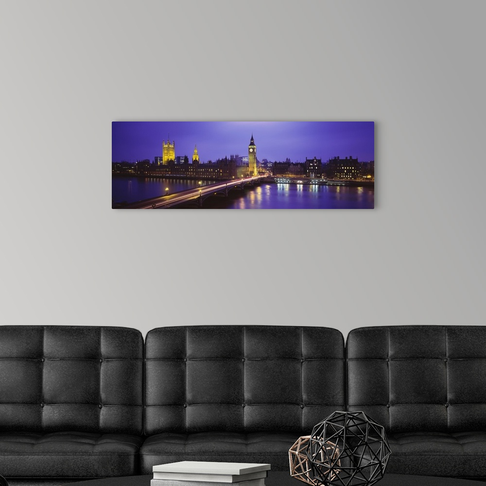 A modern room featuring Cityscape of London at twilight, showing light trails from traffic along the bridge and lights fr...