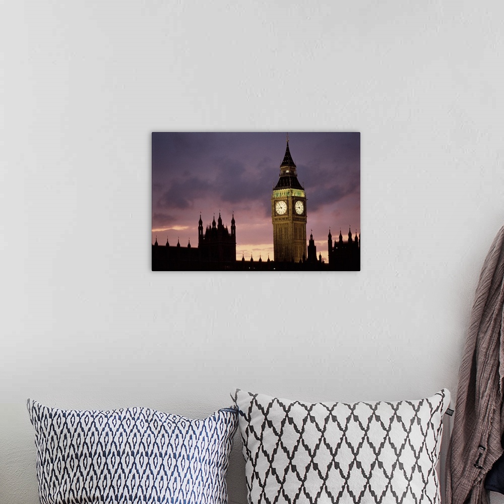 A bohemian room featuring A lit up Big Ben clock exends in to the dusk London sky rising high above the spires of Parlament...