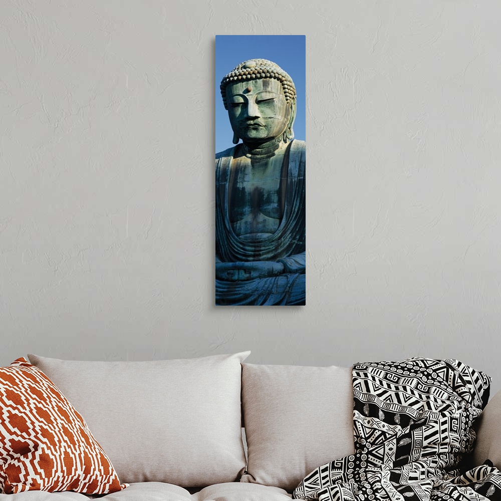 A bohemian room featuring Only part of a Buddha statue is photographed for this tall panoramic piece.