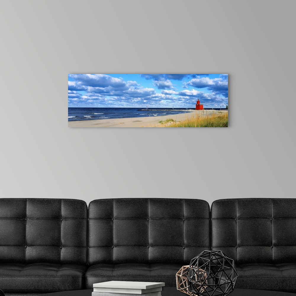 A modern room featuring Panoramic photograph of a large lighthouse next to a dock on a sandy beach in Holland, Michigan d...