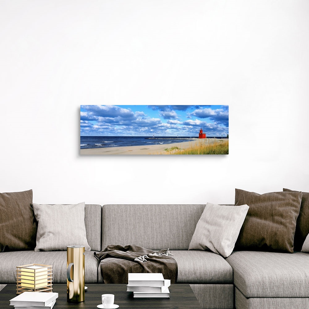 A traditional room featuring Panoramic photograph of a large lighthouse next to a dock on a sandy beach in Holland, Michigan d...