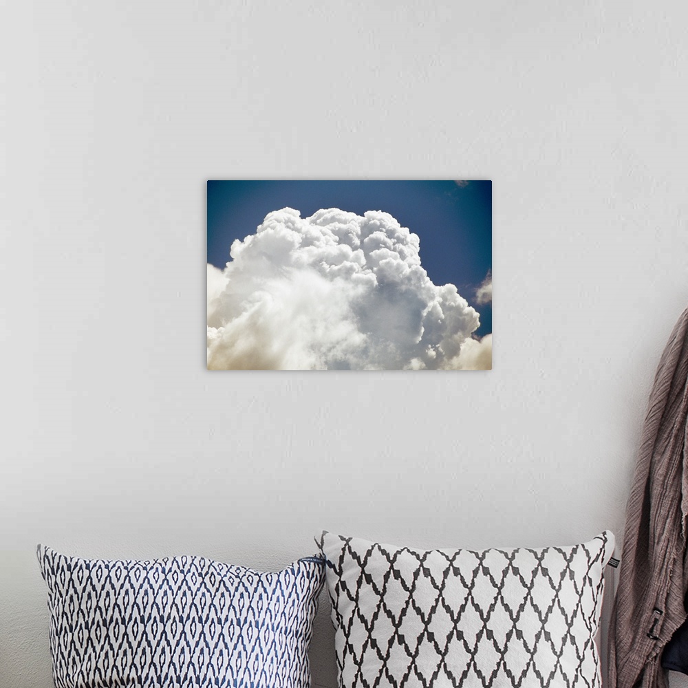 A bohemian room featuring Billowing white clouds, blue sky.