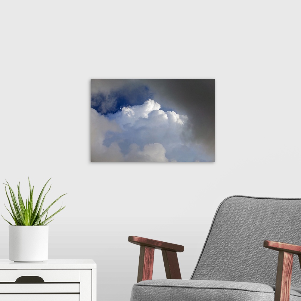 A modern room featuring Billowing white clouds in sunset light.