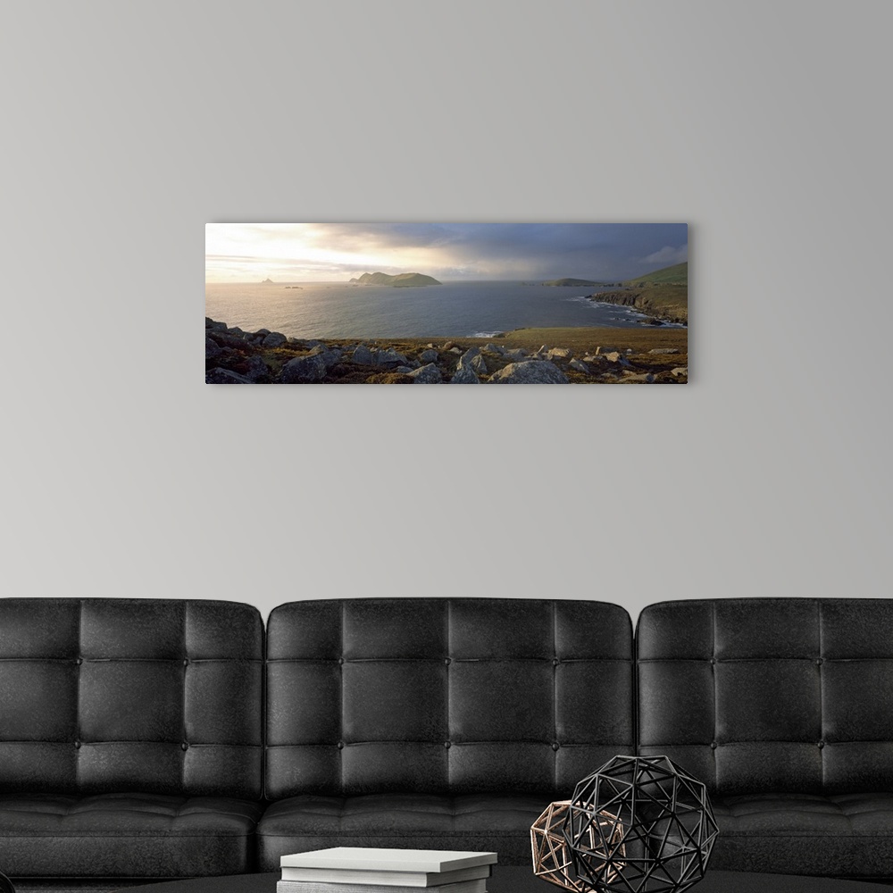 A modern room featuring This is a panoramic photograph of the view over a rocky sea cliff and the Atlantic Ocean beyond.