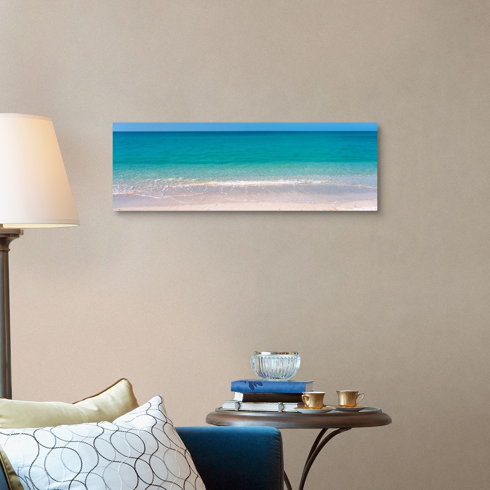 A traditional room featuring A panoramic photograph of a calm sea of tropical colored water.