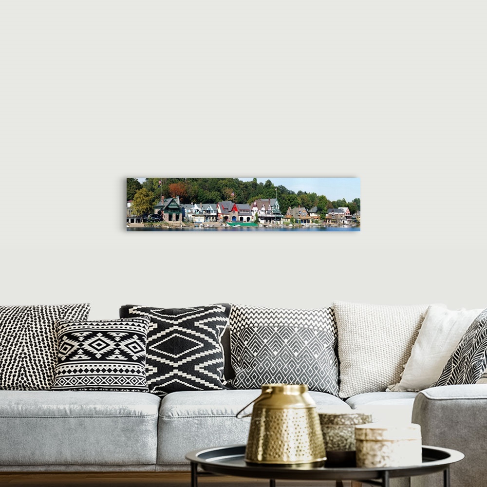 A bohemian room featuring A panoramic photograph taken at midday in late summer of the boat houses that line the river.