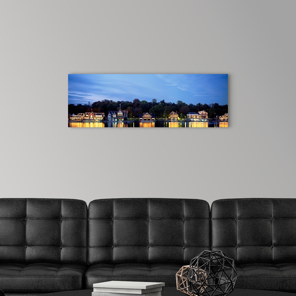 A modern room featuring Panoramic photograph taken of Boathouse Row in Philadelphia at night with a backdrop full of tree...