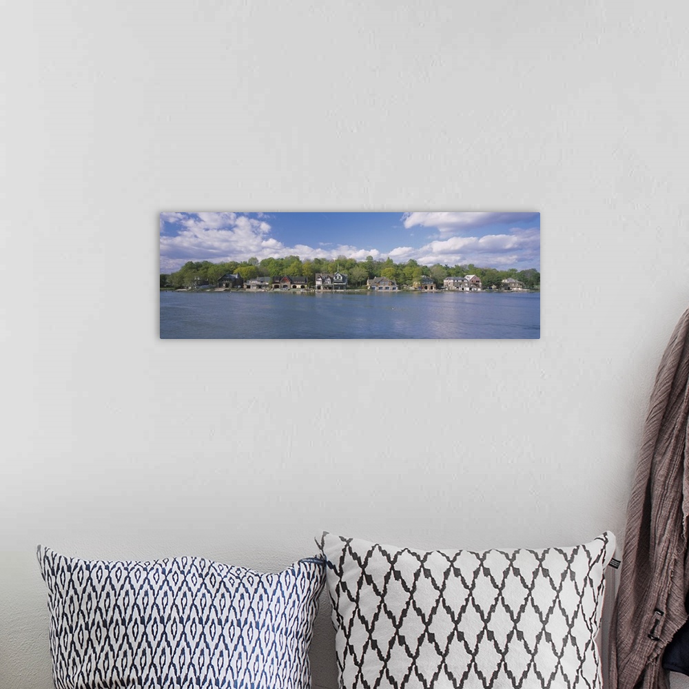 A bohemian room featuring Panoramic photo of boathouses lining a waterfront.
