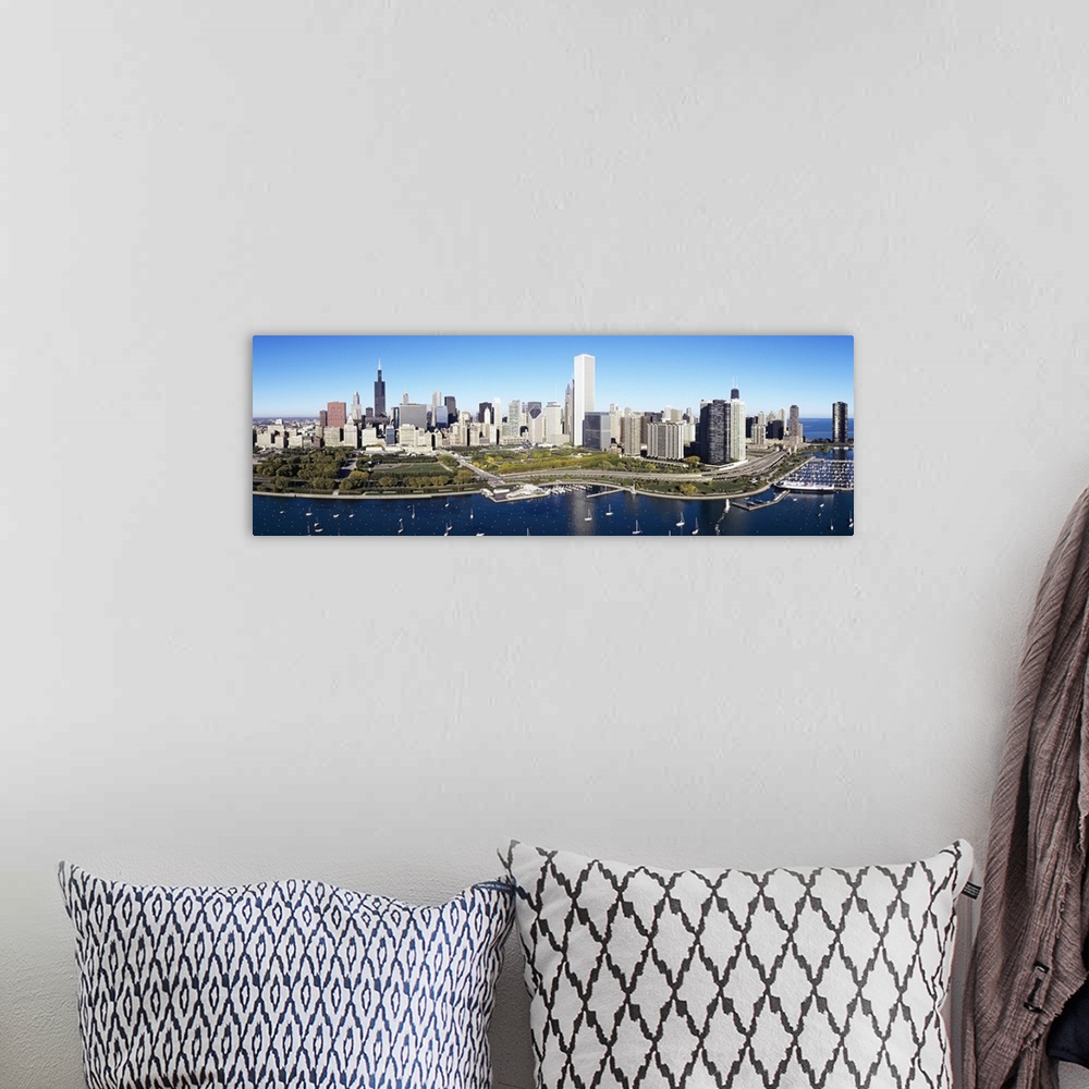 A bohemian room featuring A large panoramic photograph taken of a harbor in Chicago with multiple boats anchored in the wat...