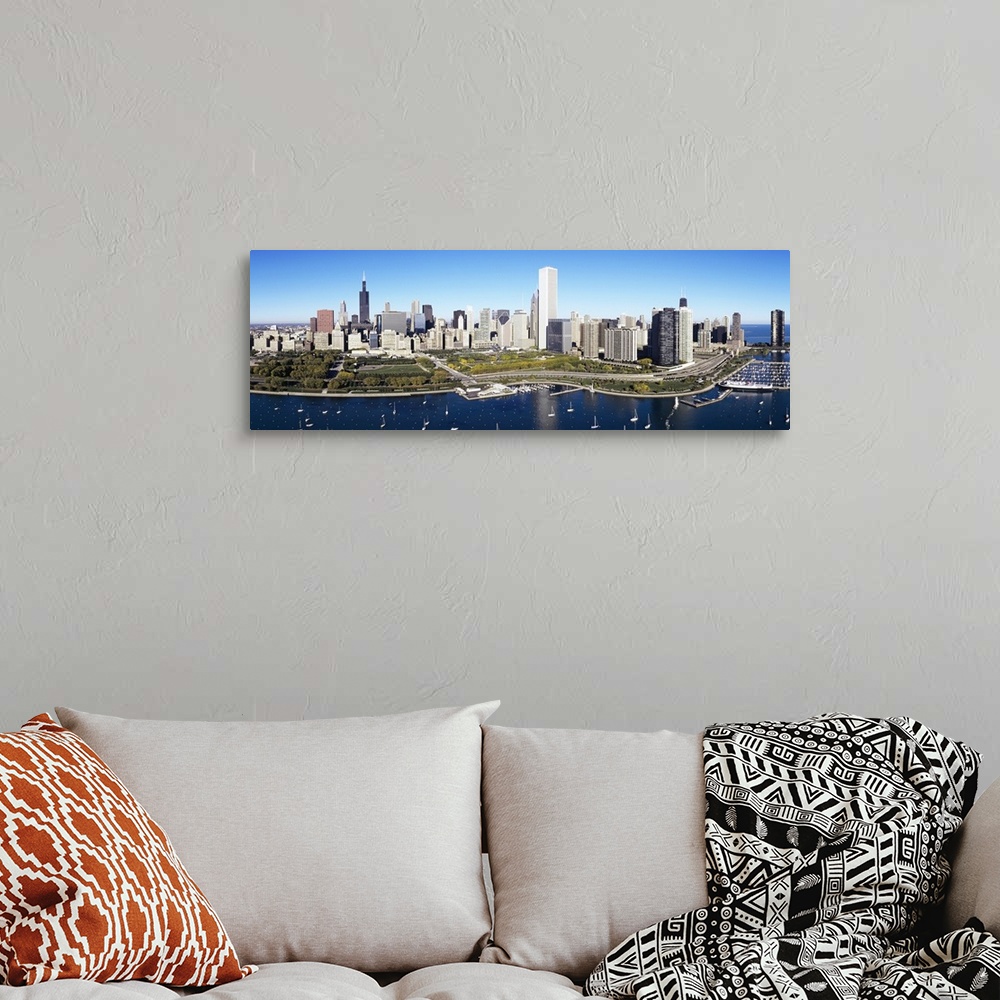 A bohemian room featuring A large panoramic photograph taken of a harbor in Chicago with multiple boats anchored in the wat...