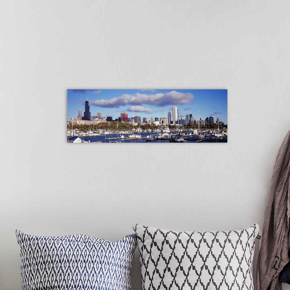 A bohemian room featuring The Chicago skyline is a backdrop to a wide angle photograph taken of the harbor with several boa...