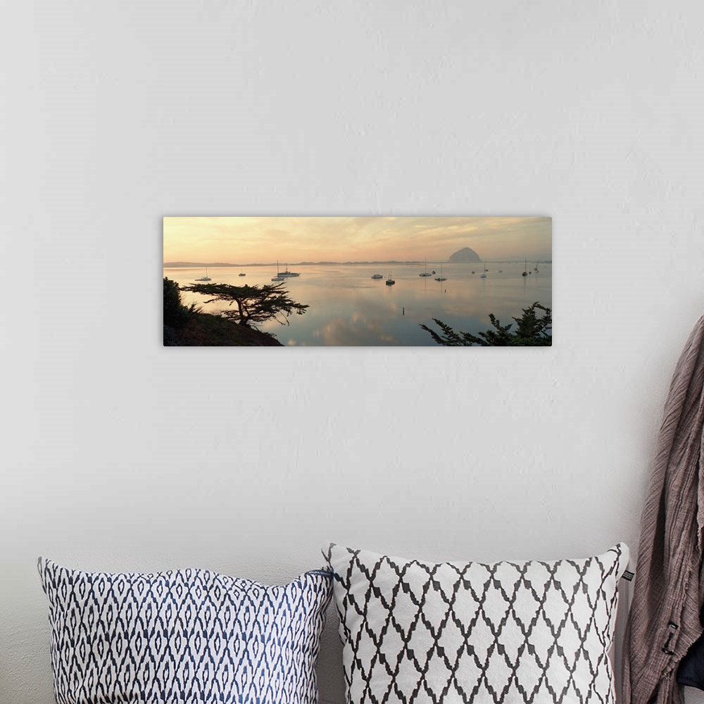A bohemian room featuring Wide angle photograph on a big canvas looking over a hillside at many small boats in the still wa...