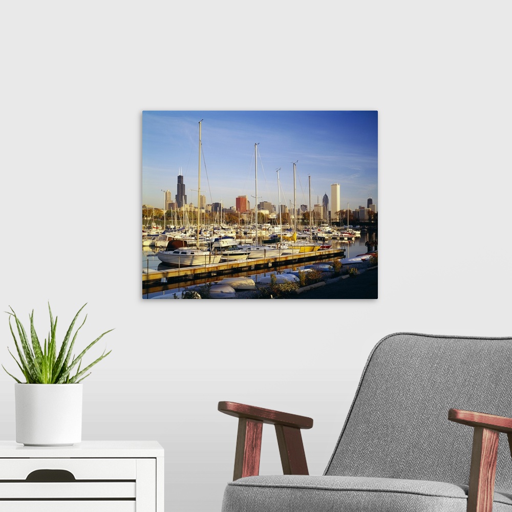 A modern room featuring This oversize piece is a picture taken of a line of boats docked in the waterfront near Chicago.