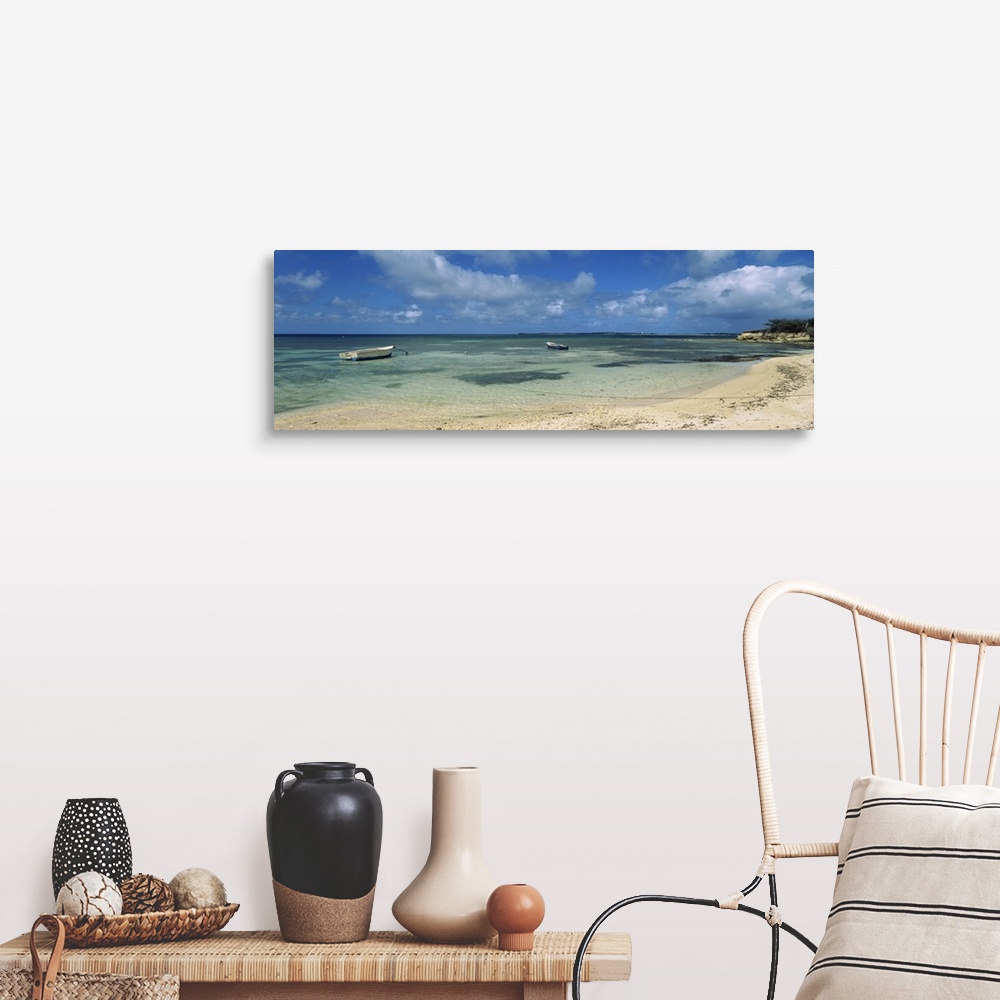 A farmhouse room featuring Long horizontal image on canvas of boats floating in the ocean near a shore.