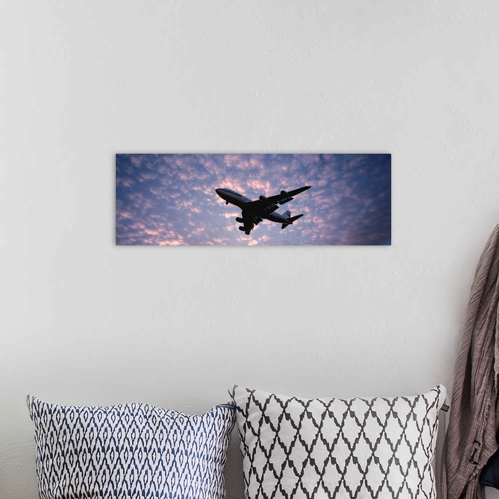 A bohemian room featuring Panoramic photograph showcases the near silhouette of a wide-body commercial airliner and cargo t...