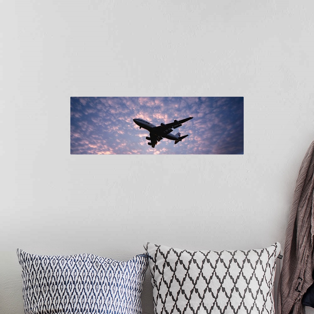 A bohemian room featuring Panoramic photograph showcases the near silhouette of a wide-body commercial airliner and cargo t...