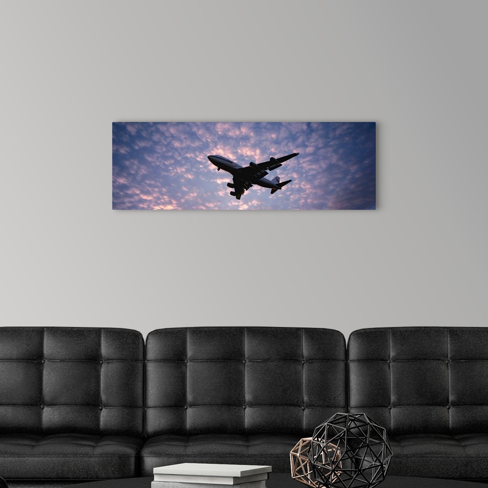 A modern room featuring Panoramic photograph showcases the near silhouette of a wide-body commercial airliner and cargo t...