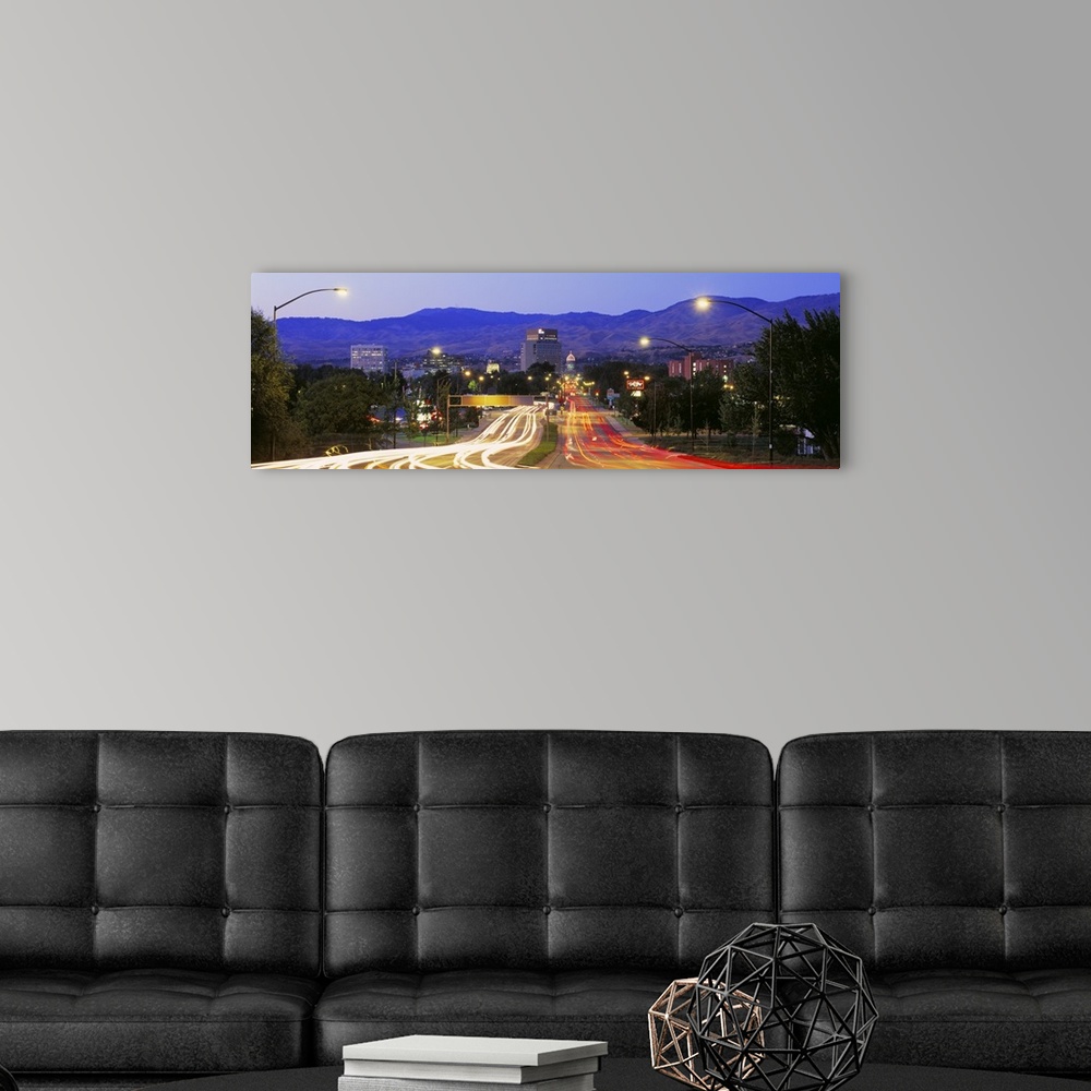 A modern room featuring Panoramic photograph taken of a major highway in Boise with the lights of the cars shown as strea...