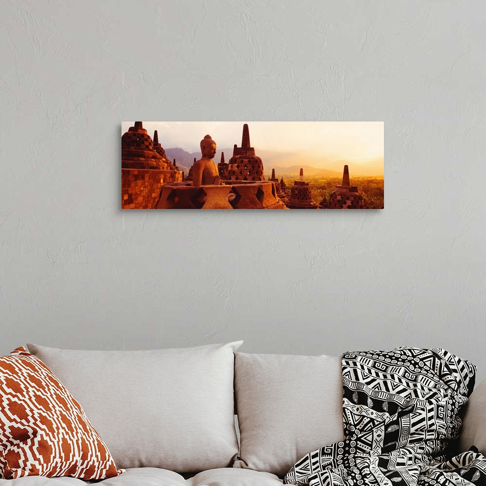 A bohemian room featuring Panoramic photograph of the top of Borobudur Buddhist Temple overlooking Java, Indonesia during a...