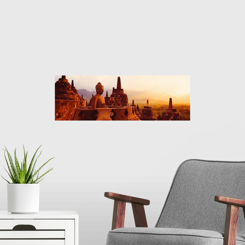 A modern room featuring Panoramic photograph of the top of Borobudur Buddhist Temple overlooking Java, Indonesia during a...