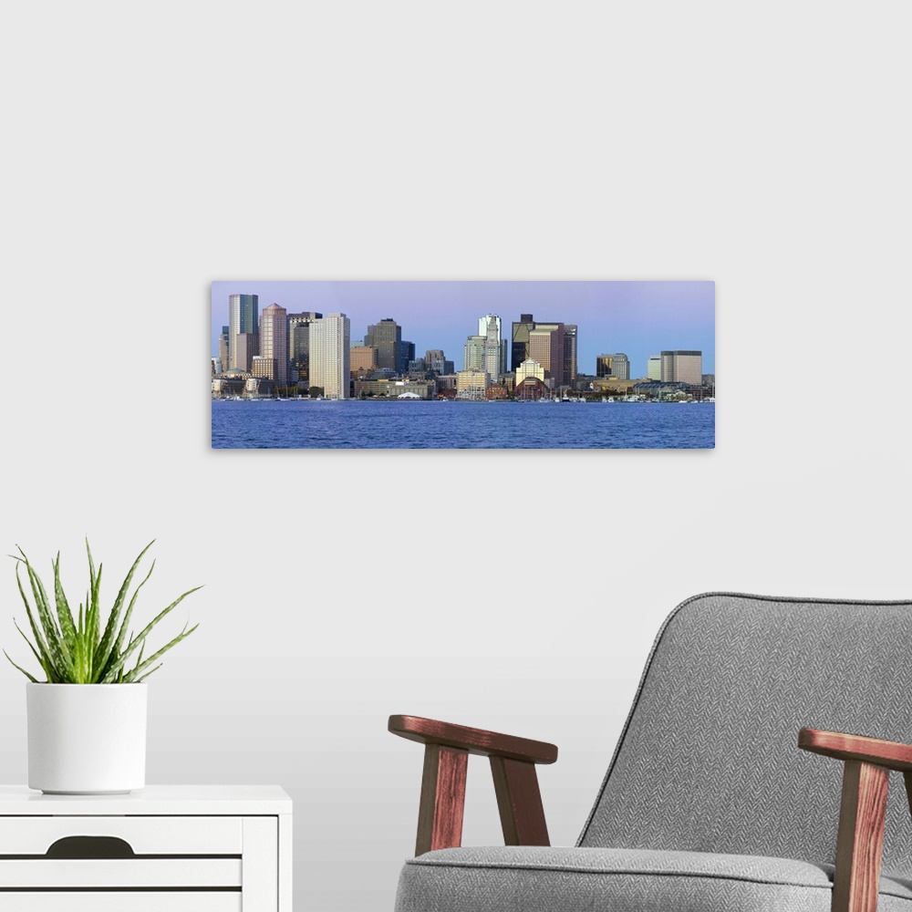 A modern room featuring Panoramic of Boston Harbor and the Boston skyline at sunrise as seen from South Boston, Massachus...