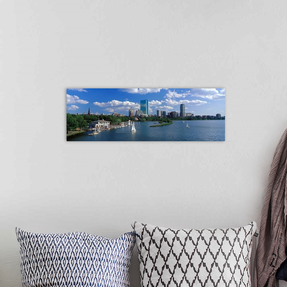 A bohemian room featuring Panoramic photograph of skyline and waterfront under a cloudy sky, with sailboats in the water.